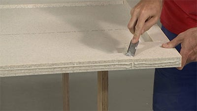 chisel off the excess adhesive from the build up