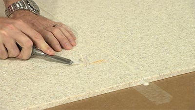 scraping excess glue off with a chisel