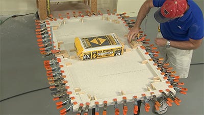 clamping the end of the block and adding a weighted item while the seam block cures