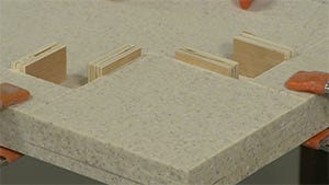 applying adhesive to the corners