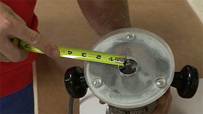 measuring the distance of the router bit to determine the cut offset