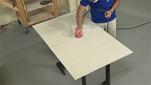prepping the material by sanding the seam out of the material