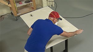sanding the material with a sanding block