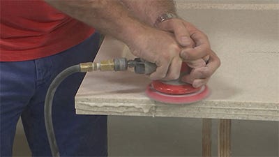 sanding the final edge build-up with an orbital sander