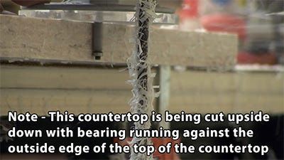 cutting the build up using a flush trim bit with the bearing running against the top